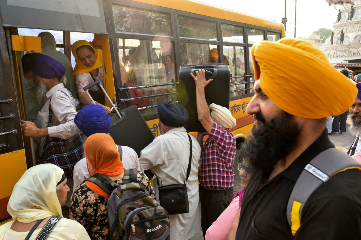 Sikh pilgrims board a bus as they leave for Pakistan to celebrate 'Baisakhi', a spring harvest festival, in Amritsar on April 13