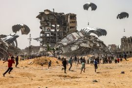 People rush to landing humanitarian aid packages dropped over the northern &lt;span&gt;Gaza Strip&lt;/span&gt;. [AFP]