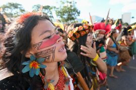 Members of the Pataxo ethnic group march in Brasilia as part of the Acampamento Terra Livre (Free Land Camp). [Evaristo Sa/AFP]
