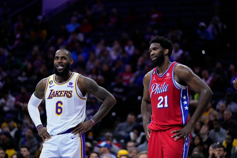 Los Angeles Lakers' LeBron James (6) and Philadelphia 76ers' Joel Embiid on the court.