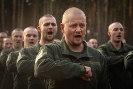 New recruits celebrate the end of their training at a military base near Kyiv, Ukraine [Efrem Lukatsky/AP]