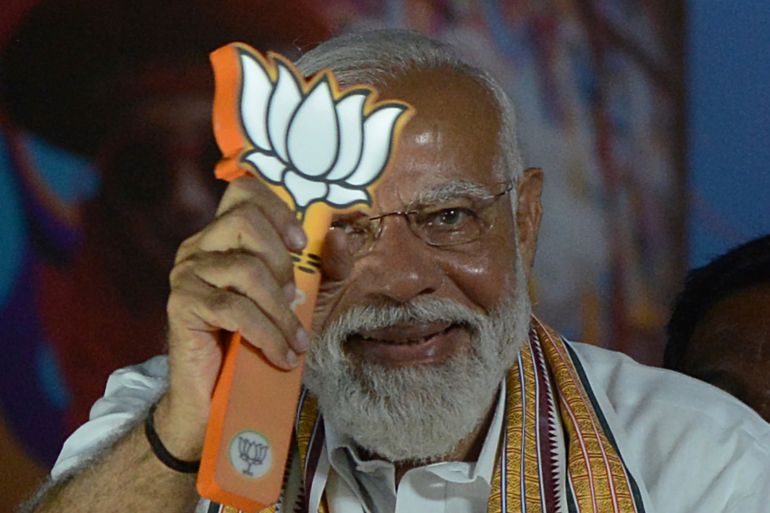 Indian Prime Minister Narendra Modi displays the Bharatiya Janata Party (BJP) symbol, lotus, during a road show while campaigning for national elections, in Chennai, India