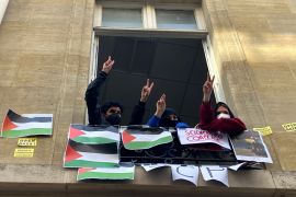 Students blocking the Paris Institute of Political Studies flash the victory sign. [Jeffrey Schaeffer/AP Photo]