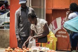 Vendors do business in US dollars on the streets of Harare, Zimbabwe [Calvin Manika/Al Jazeera]