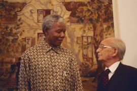 A 1995 photograph of President Nelson Mandela, left, with Percy Yutar, the prosecutor in the 1963-1964 Rivonia treason trial, in which Mandela was sentenced to life in prison [File: Louise Gubb/Corbis Saba via Getty Images]