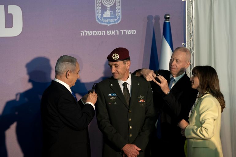 Sharon Halevi, right, watches as Israeli Prime Minister Benjamin Netanyahu, left, and Defense Minister Yoav Gallant, second right, promote her husband, the new Israel Defense Forces Chief of Staff Herzi Halevi to the rank of Lieutenant-General in Jerusalem