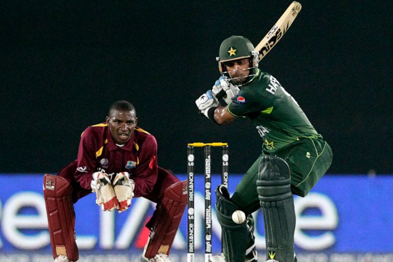Pakistan's Mohammad Hafeez plays a shot as West Indies' wicketkeeper Devon Thomas looks on during their Cricket World Cup 2011 quarter-final