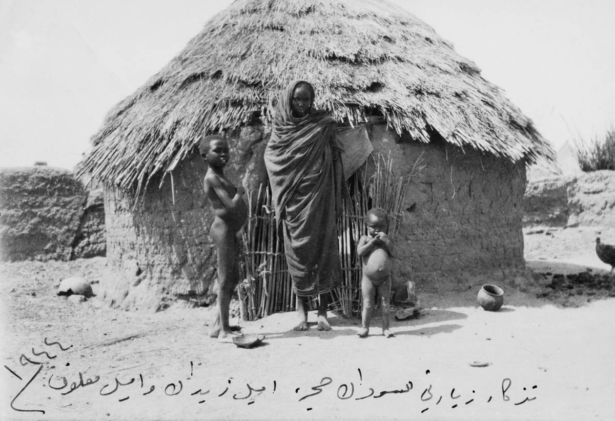 Elias Mirshak's trip to Sudan - Natives in front of a hut, Sudan, 1944. [Emma Fahoum/Arab Image Foundation]