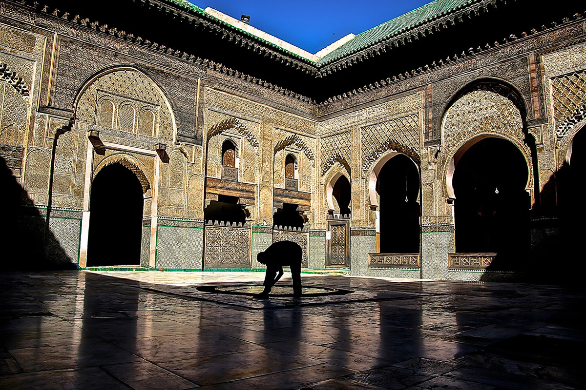 In Fez's Madrasa Bou Inani, a man performs ablutions, or 'wudu', in preparation for the noon prayer, Dhuhr. Prayer five times a day is obligatory all year round, and in Ramadan there are additional prayers, such as the Tarawih in the evening. [Venetia Menzies/Al Jazeera]
