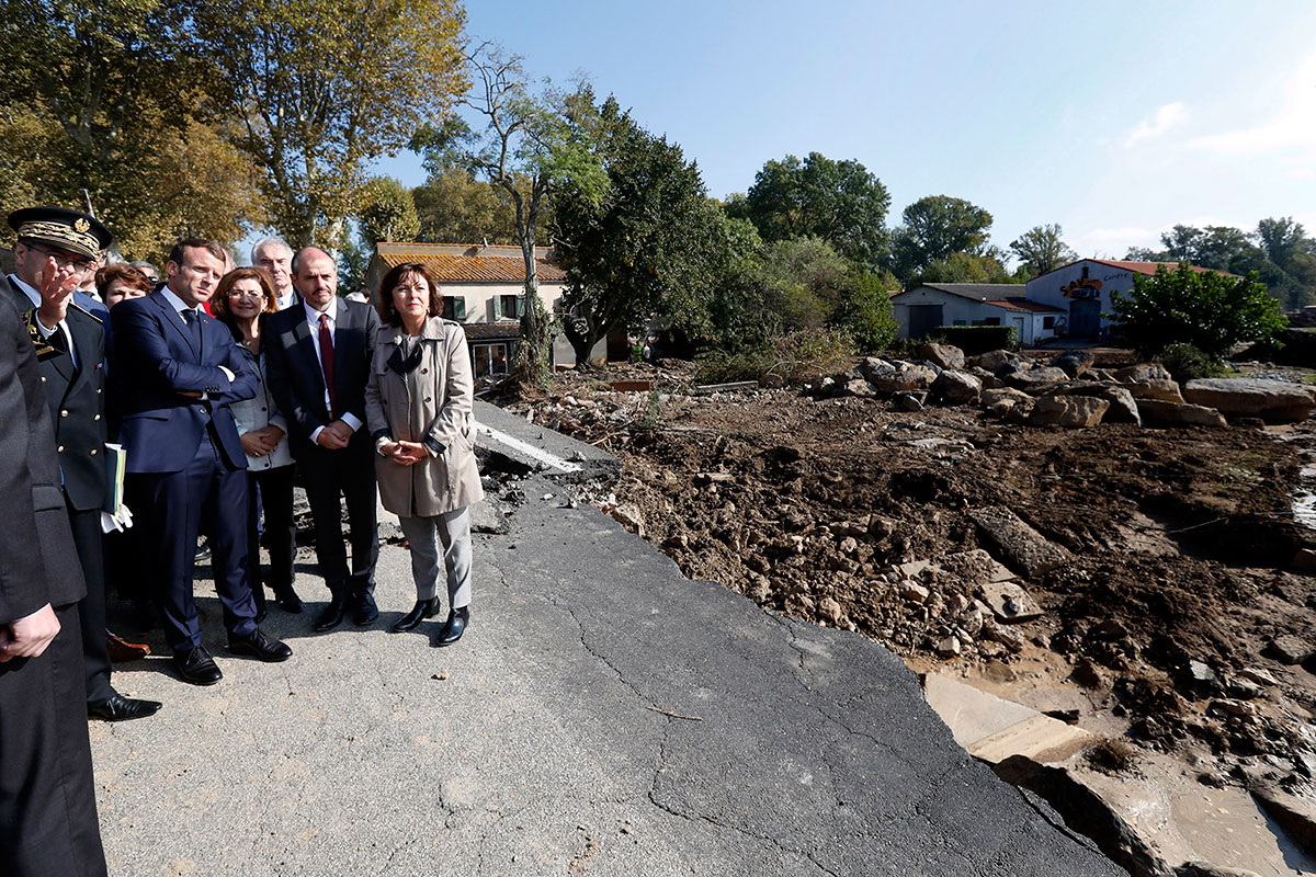 President Macron surveys the flood damage caused by heavy rain in Villalier, France. [Guillaume Horcajuelo/EPA]