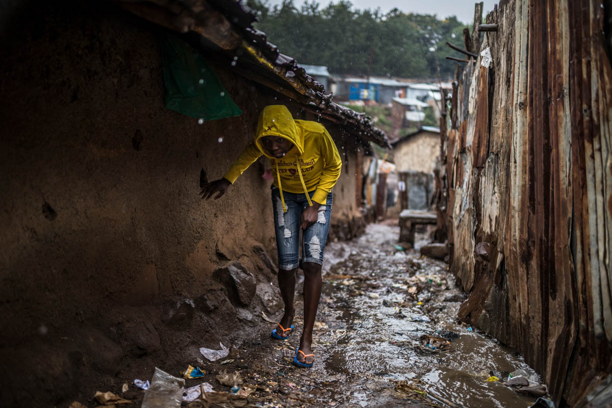 During the rainy season, Kibera's narrows alleys transform into a mess of red mud, rubbish, human waste and plastic shreds. [Brian Otieno/Al Jazeera]