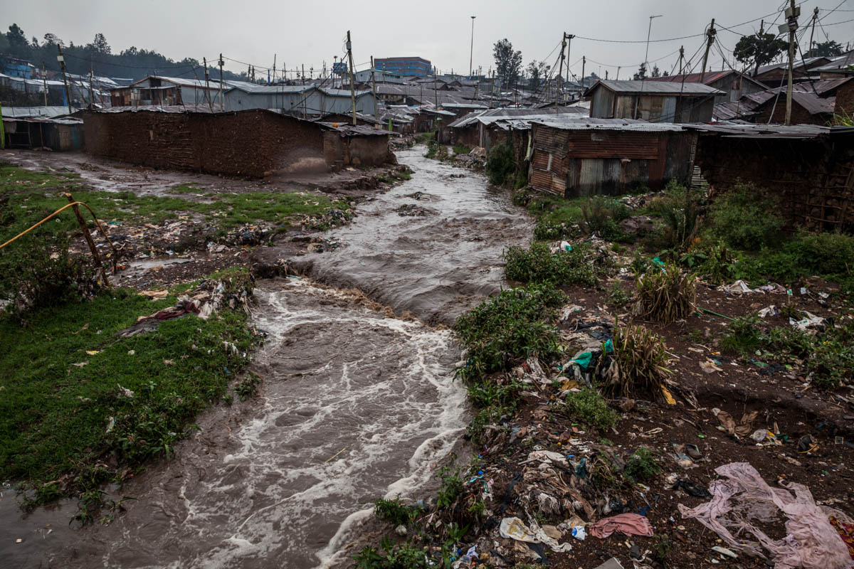 Cutting along the settlement's western boundary, the river is associated with death and destruction of property during the rainy season. [Natalia Jidovanu/Al Jazeera]