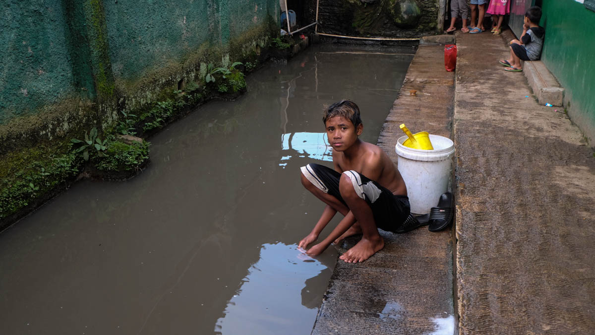 Jajang, 16, along with other people from his village has been using Citarum River to bath, wash dishes and clothes. He is suffering from skin disease from using the polluted water. [Syarina Hasibuan/Al Jazeera]