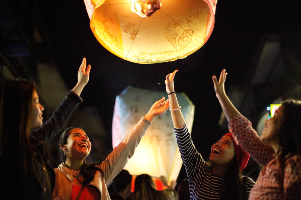 Margareth,Mitzuris, Michelle and Lizeth, students from Panama and Indonesia release their flying lantern painted and handwritten with their wishes. There are wishes about studies, traveling together, working out, enjoying different cuisines, relationships and happiness. [Yunjie Liao/Al Jazeera]