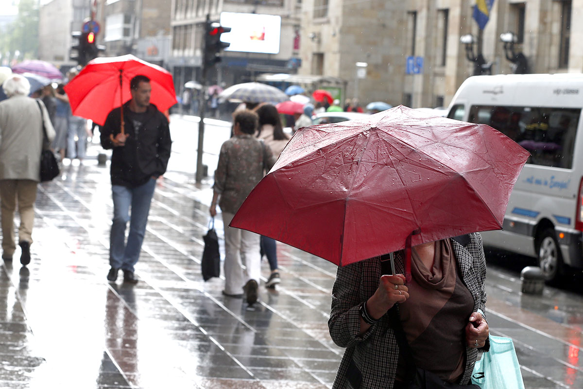 Not all of Europe is enjoying the warm weather. In Sarajevo, umbrellas were up as thunderstorms raged across Bosnia and Herzegovina [Fehim Demir/EPA-EFE]