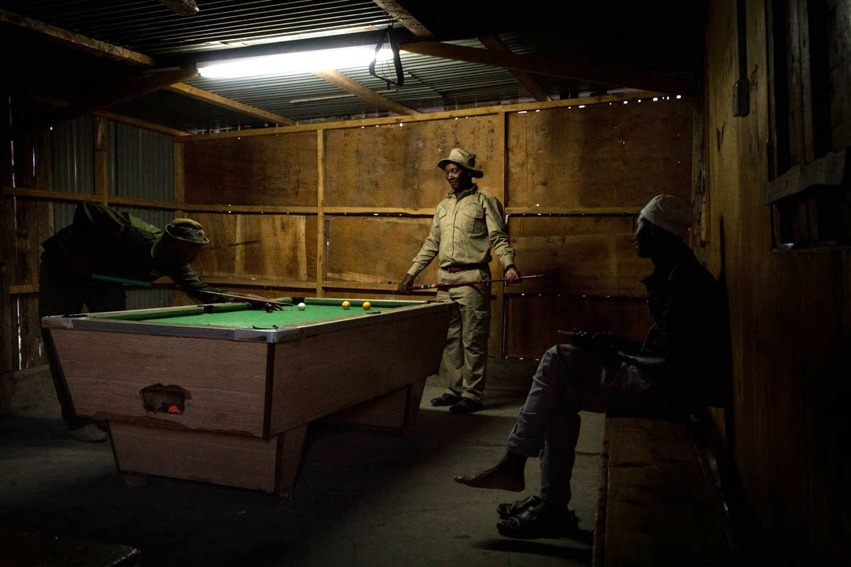 Rangers and chimp keepers play pool in the evening at the Ol Pejeta Conservancy. [Adriane Ohanesian/Al Jazeera]