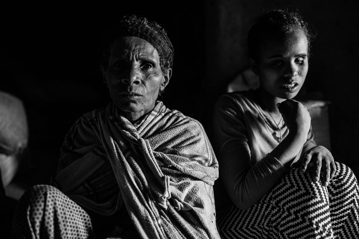 Eniyat Belete (right) is 17. She has been blind since birth. In her village, as in many other towns all over Ethiopia, disability comes with a heavy stigma. "They believe I was cursed with blindness because God was angry," explains the teenager. Despite the neighbours' prejudice against her daughter's impairment, her mother says: "I will support her education, whatever financial sacrifice it may take. God gave her to us this way, and we love her [the way she is]." [Nathalie Bertrams/Al Jazeera]