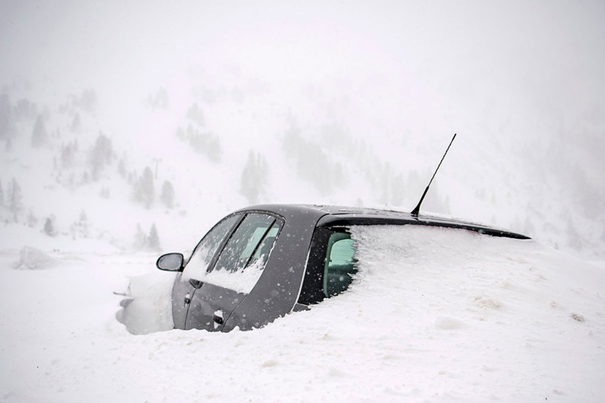 A car covered in snow in Obertauern, Austria. The storms have trapped motorists in their vehicles in Germany and stranded residents and tourists in Austrian alpine villages cut off by blocked roadways. [Christian Bruna/EPA]