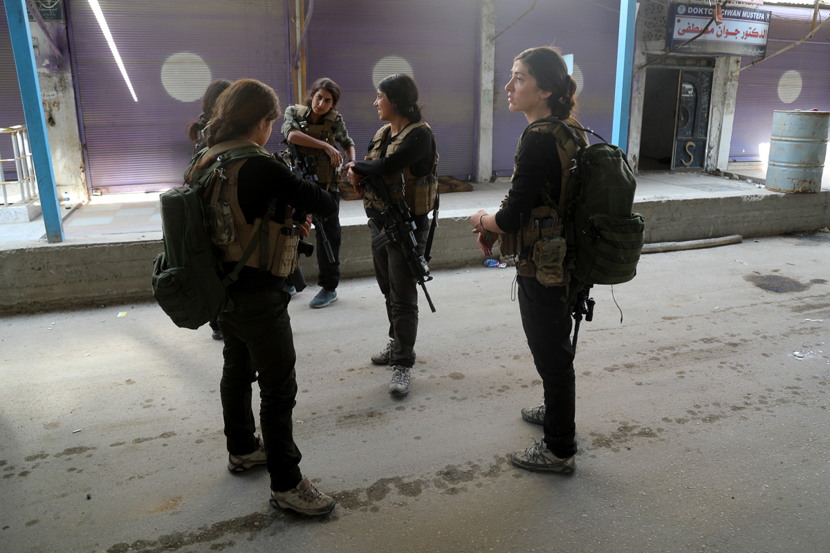 Kurdish female fighters of the SDF gather in Ras al-Ain. Turkey's ministry of defence said 399 YPG fighters had been 'neutralised' since the operation began on Wednesday. Stringer/EPA]