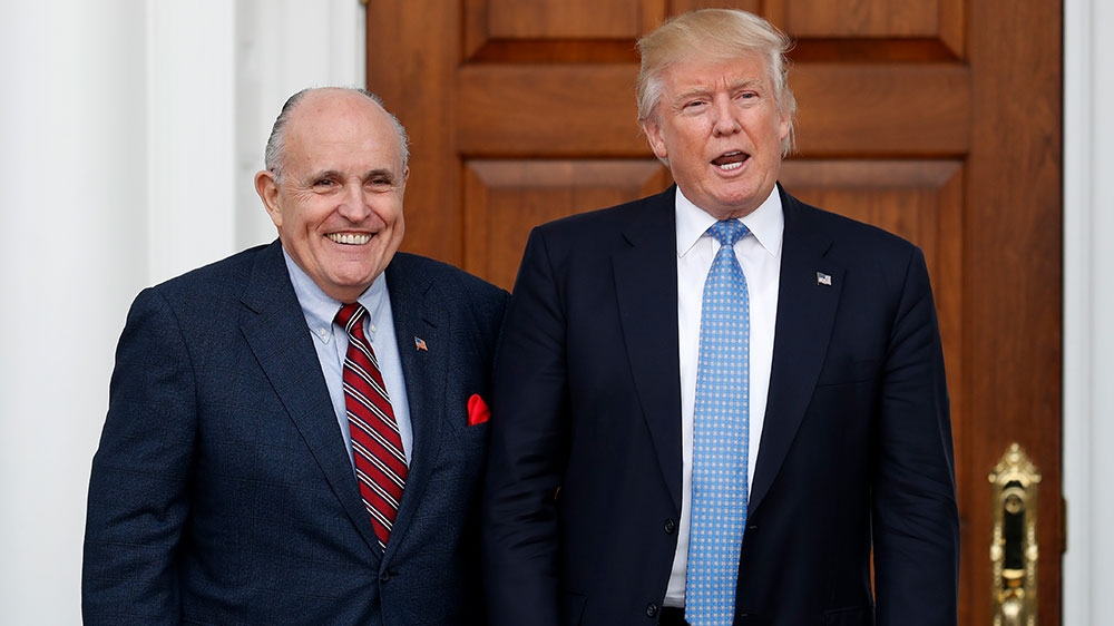 Trump and Giuliani pose for photographs [File: Carolyn Kaster/AP Photo] 