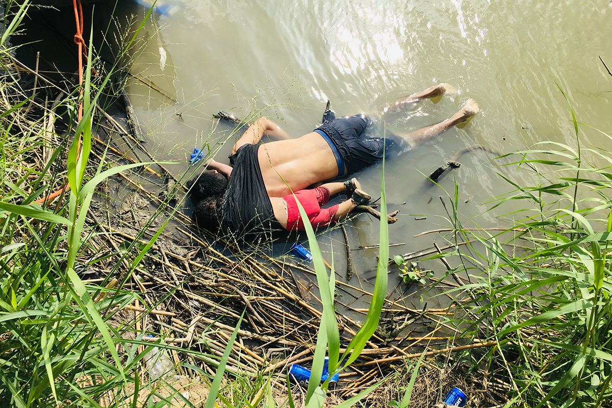 The bodies of Salvadoran Oscar Alberto Martinez Ramirez and his 23-month-old daughter Valeria lie on the bank of the Rio Grande in Matamoros, Mexico, Monday, June 24, 2019, after they drowned trying to cross the river to Brownsville, Texas. Martinez's wife Tania told Mexican authorities she watched her husband, an undocumented migrant, and child disappear in the strong current. [Julia Le Duc/AP Photo]
