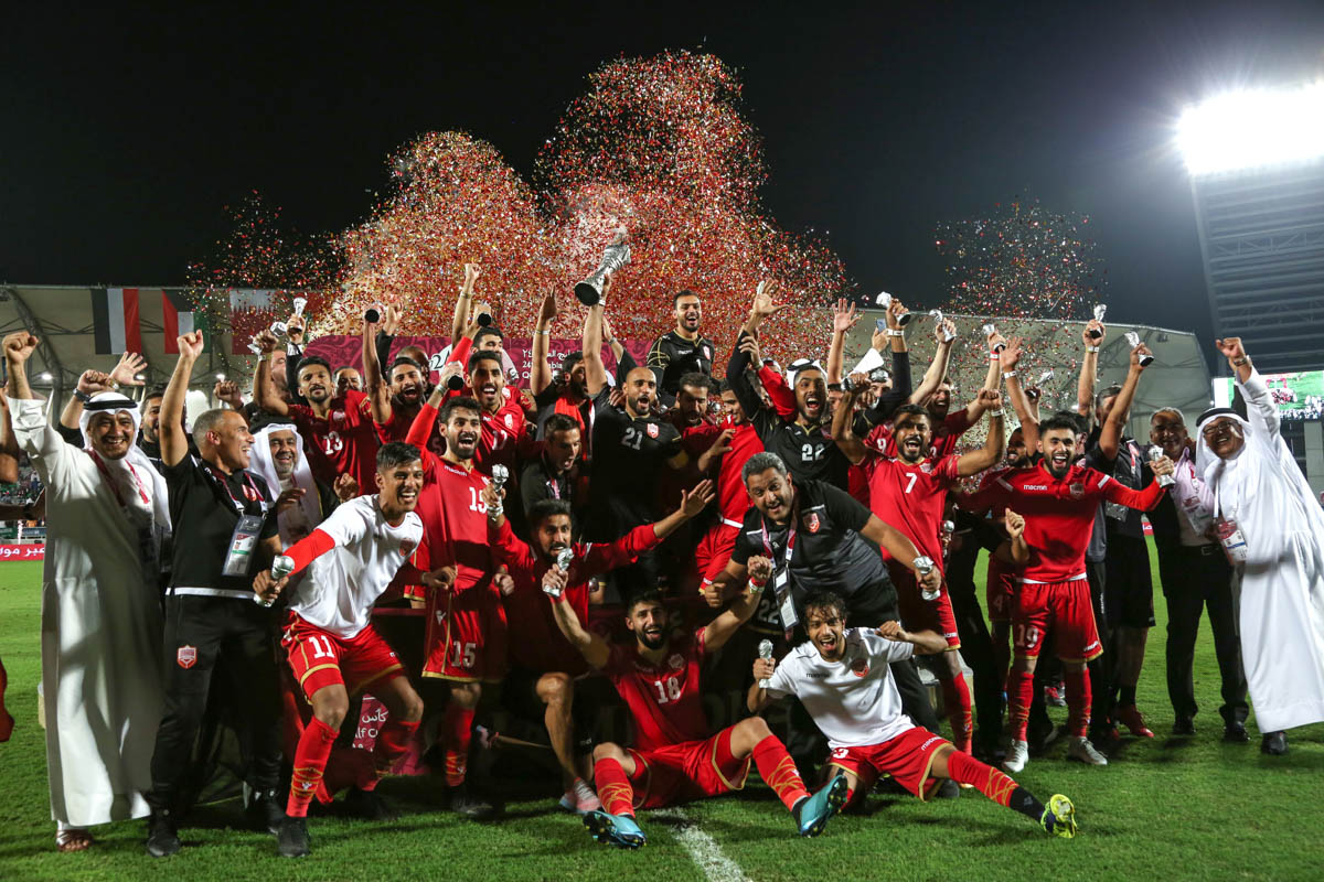 Bahraini players lift their first-ever regional title at the Arabian Gulf Cup. [Showkat Shafi/Al Jazeera]