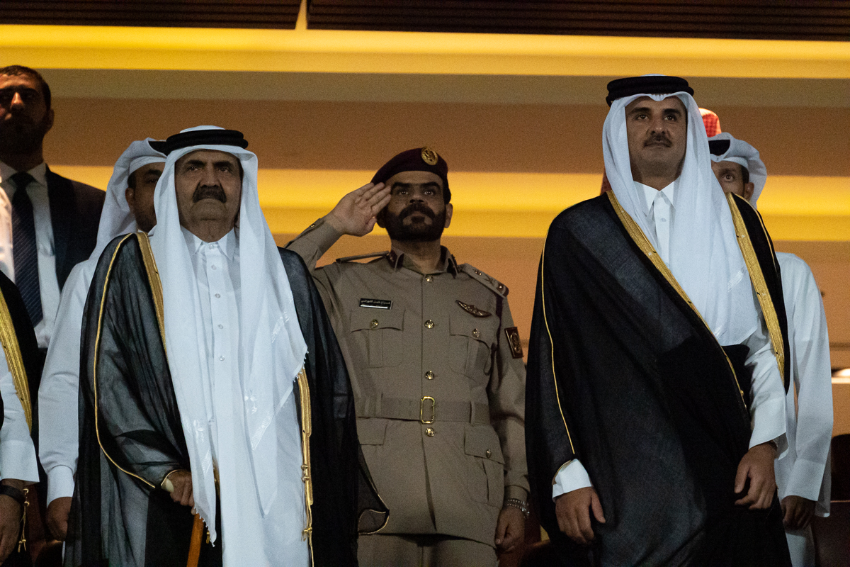 Qatar's emir, Sheikh Tamim bin Hamad Al Thani, and the emir's father, Sheikh Hamad Bin Khalifa Al Thani, stand for the national anthems of Bahrain and Saudi Arabia. [Sorin Furcoi/Al Jazeera]