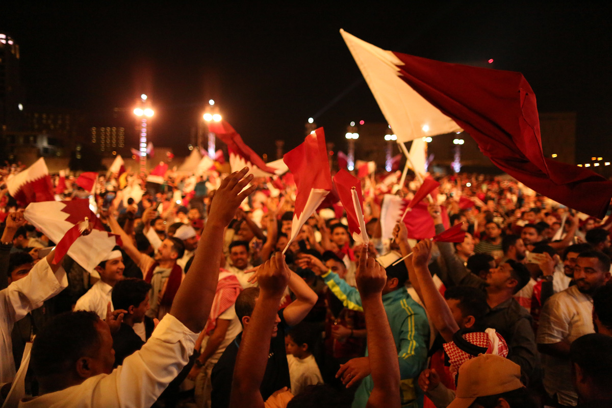 Jubilant citizens cheering in Doha after Qatar won its first major football title, the Asian Cup. [Showkat Shafi/Al Jazeera]