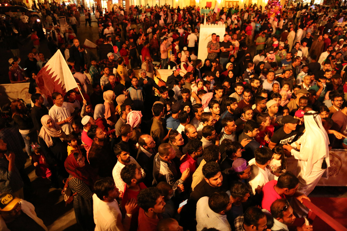People celebrate victory in Qatar's Souq Waqif. The team won every one of their seven matches in the tournament. [Showkat Shafi/Al Jazeera]