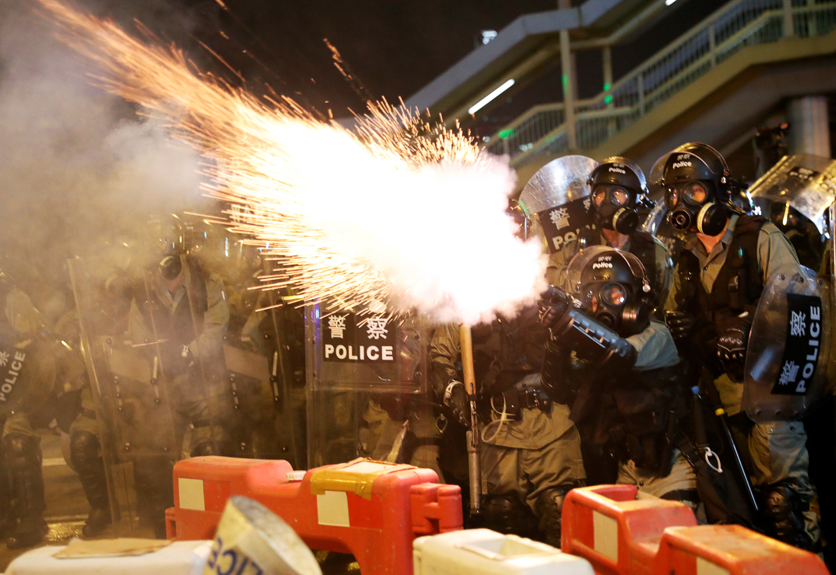 Police fire tear gas to disperse protesters on Sunday. [Kim Kyung-Hoon/Reuters]