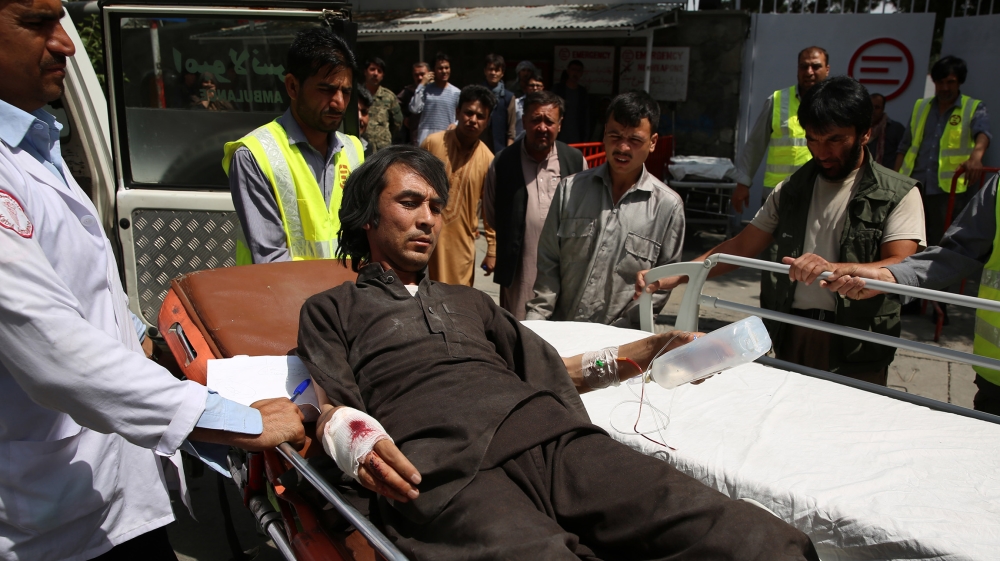 Afghan health workers transport a wounded man to a hospital after bomb explosion and gun fight that targeted a police station in a heavy residential area of Kabul, Afghanistan, 07 August 2019. Accordi