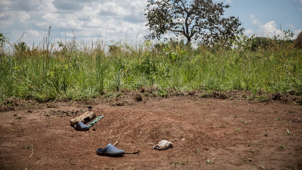 The grave of Stewart Rubamga-Kwo, a 12-year-old who died on March 31 after he was unable to get transport to travel 20km to a hospital. [Sally Hayden/Al Jazeera]