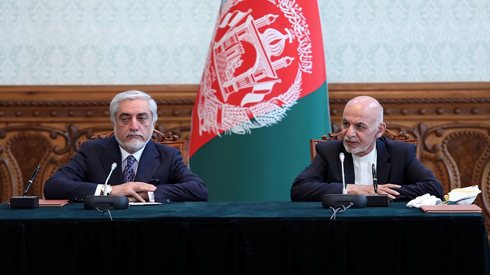 Afghanistan's President Ashraf Ghani and his rival Abdullah Abdullah attend a ceremony to sign a political agreement in Kabul, Afghanistan May 17, 2020. Afghan Presidential Palace/Handout via REUTERS 