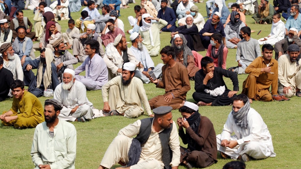 Men wait to receive free food donated by the Afghan government, amid the spread of the coronavirus disease (COVID-19), in Jalalabad, Afghanistan April 28, 2020. REUTERS/Parwiz