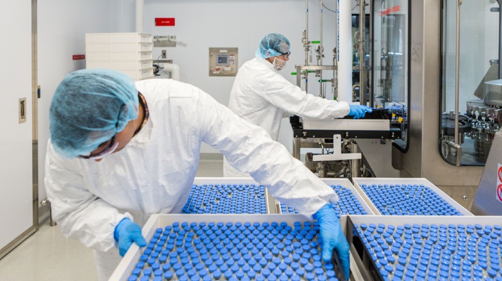 Lab technicians load filled vials of investigational coronavirus disease (COVID-19) treatment drug remdesivir at a Gilead Sciences facility in La Verne, California, U.S. March 18, 2020. 