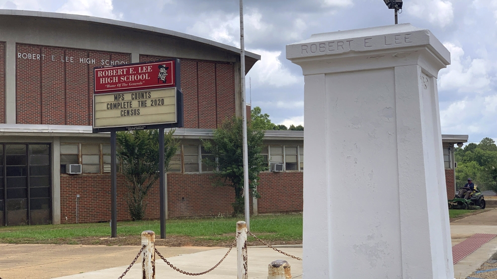 A pedestal that held a statue of Robert E. Lee stands empty outside a high school named for the Confederate general in Montgomery, Ala. on Tuesday, June 2, 2020. Four people were charged with criminal