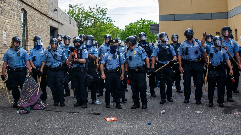 Minneapolise Police officers stand in a line while facing protesters demonstrating against the death of George Floyd outside the 3rd Precinct Police Precinct in Minneapolis, Minnesota. Members of the 