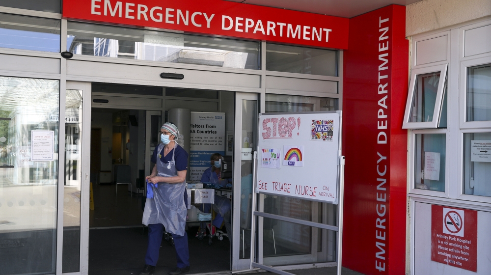 A triage nurse waits for patients to arrive in the Emergency Department at Frimley Park Hospital Frimley Park Hospital, in Camberley, England, May 22, 2020. The hospital is part of a group saying that
