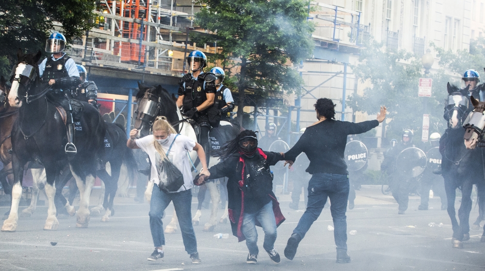 Protestors are tear gassed as the police disperse them near the White House on June 1, 2020 as demonstrations against George Floyd's death continue. Police fired tear gas outside the White House late 