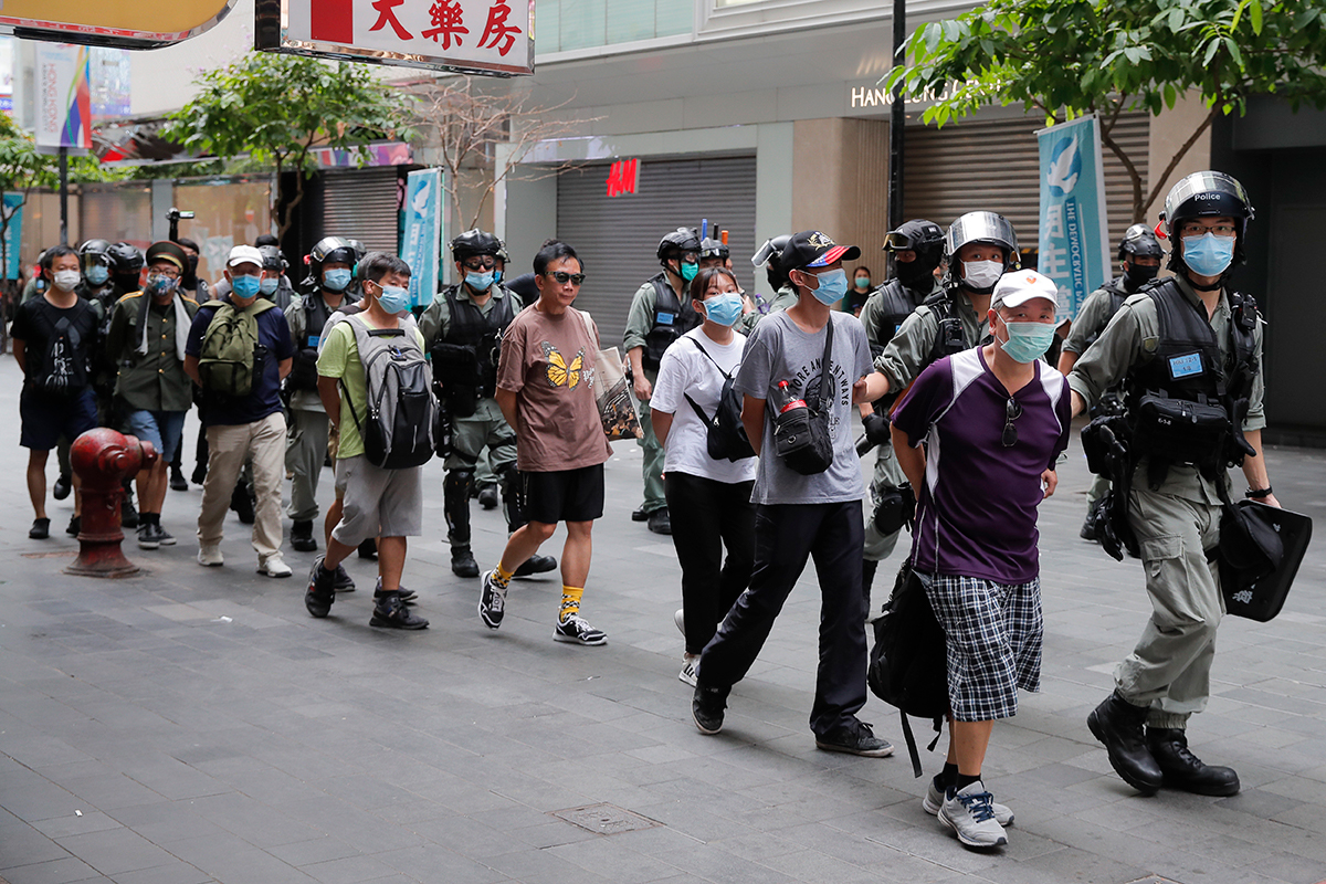 Police said they made 30 arrests for illegal assembly, obstruction, possession of weapons and violating the new law. [Kin Cheung/AP Photo]