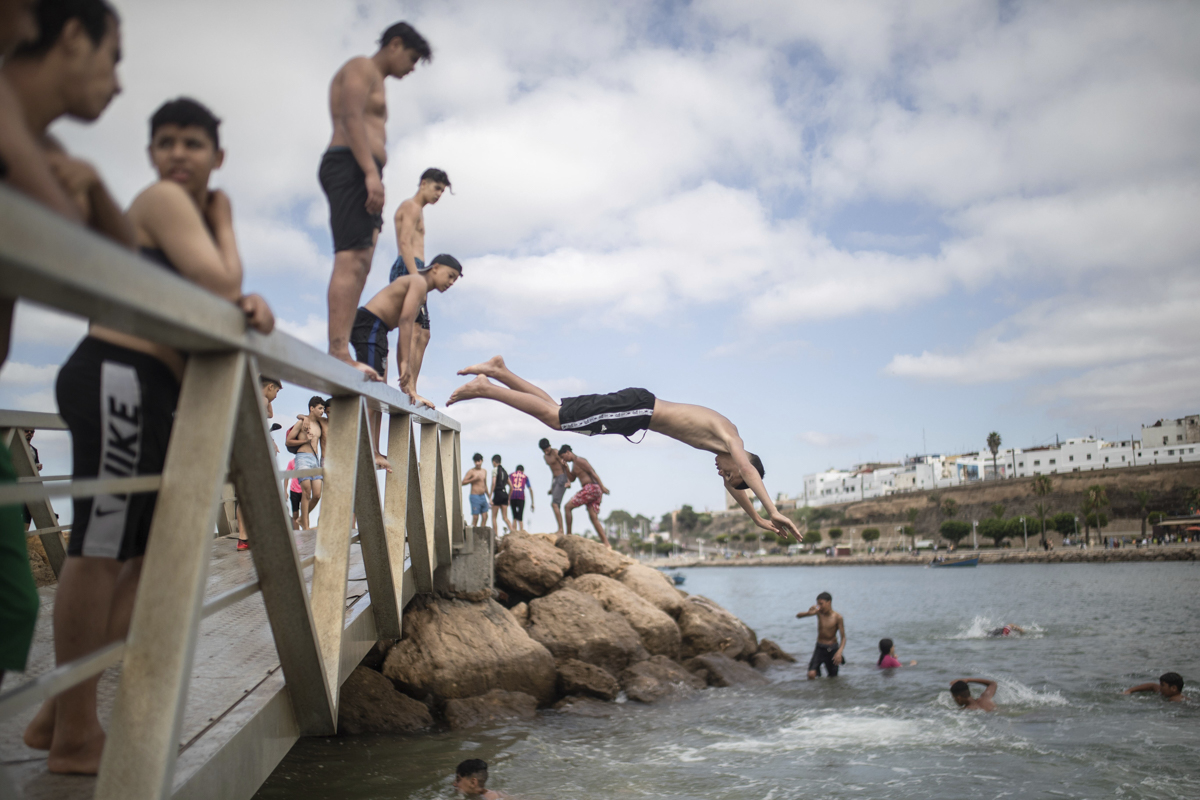 Boys jumping into a river in Rabat. [Mosa'ab Elshamy/AP Photo]