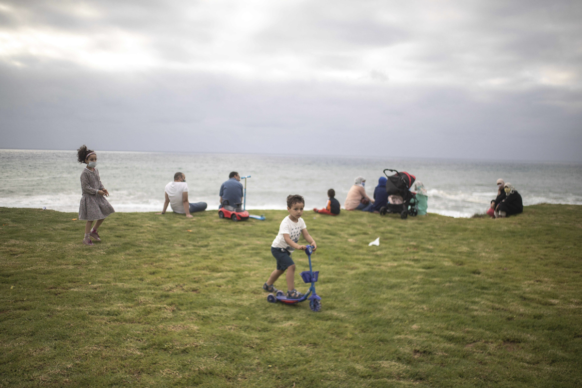 Families gathering at a beach in Rabat. [Mosa'ab Elshamy/AP Photo]
