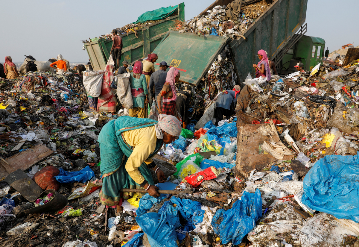 Medical waste is disposed of among the regular garbage brought to the landfill site. [Adnan Abidi/Reuters]