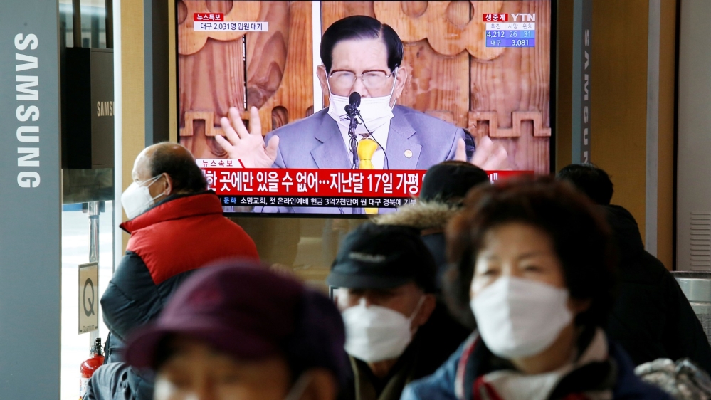 FILE PHOTO: People watch a TV broadcasting a news report on a news conference held by Lee Man-hee, founder of the Shincheonji Church of Jesus the Temple of the Tabernacle of the Testimony, in Seoul