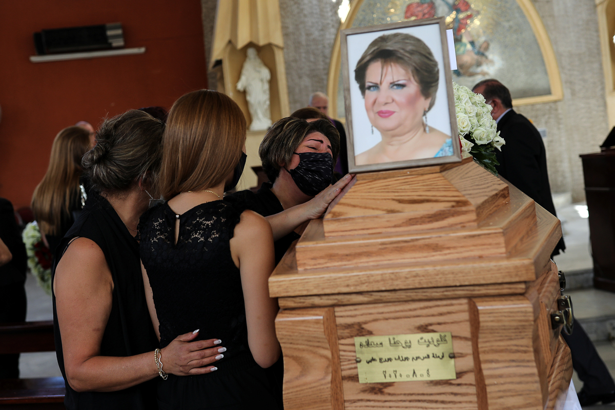 Mourners gather around the coffin of Claudette Halabi, who was killed by the explosion at the Beirut port. Her neighbours said Claudette cried out from beneath the rubble of her house for an hour before she died. [Alkis Konstantinidis/Reuters]