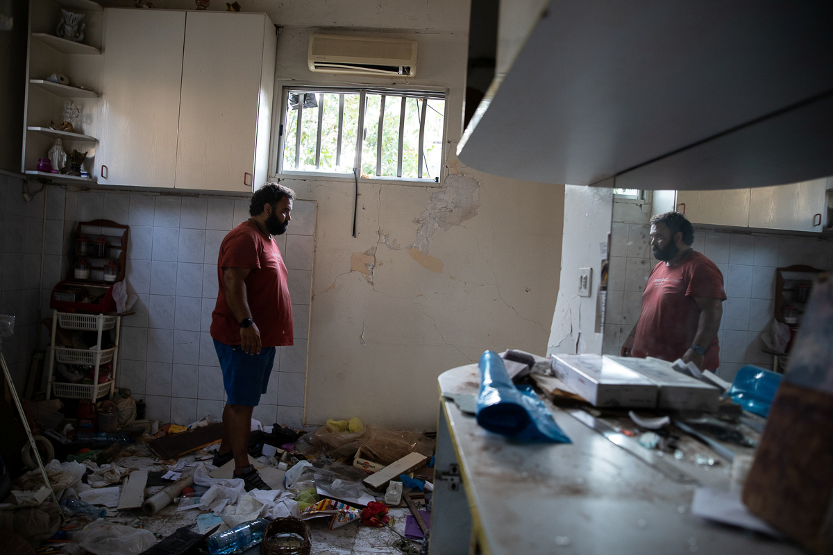 Johnny Khawand, 40, stands in what remains of his kitchen. Khawand worked with the rescuers through the night after the blast. [Alkis Konstantinidis/Reuters]