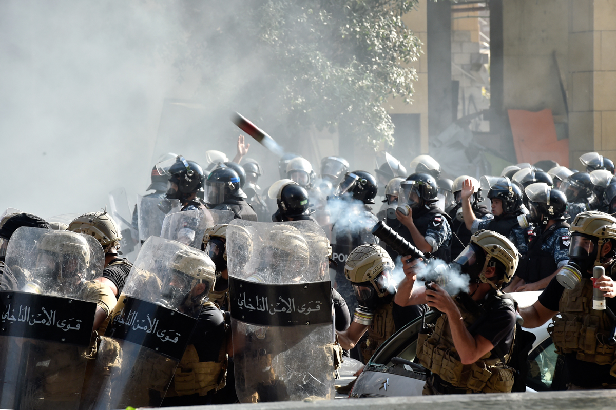 Riot police fire tear gas at protesters outside the Lebanese Parliament. The explosion at Beirut port on Tuesday killed at least 158 people, wounded 6,000 and made hundreds of thousands homeless. [Wael Hamzeh/EPA]