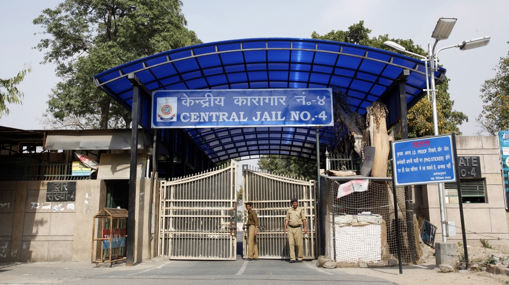 Police stand guard at one of the gates of the Tihar Jail in New Delhi March 11, 2013. The driver of the bus in which a young Indian woman was gang-raped and fatally injured in December hanged himself 