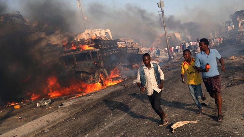 Civilians evacuate from the scene of the explosion in KM4 street in the Hodan district of Mogadishu [Reuters]