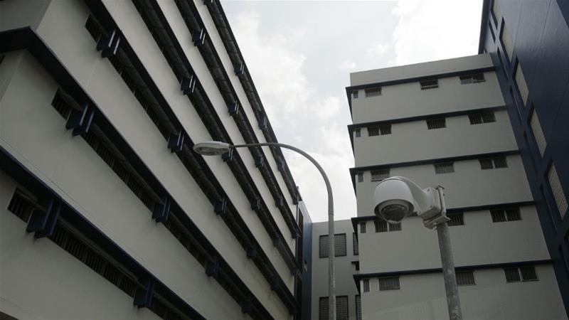 View through a vehicle window shows cell blocks inside Singapore's Changi Prison [Vivek Prakash/Reuters]